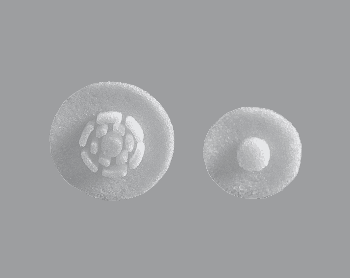 Burr Hole Cover Cranial Implants Porous Polyethylene Round white implant with central hole for burr hole coverage