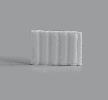 White rectangular implant with vertical channels for drainage
