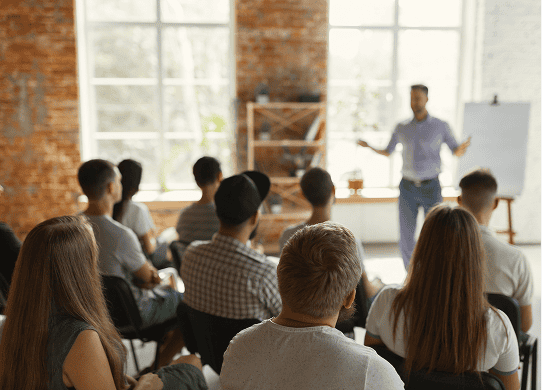 Business presenter training group of professionals in conference room setting