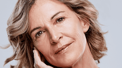 Woman with natural-looking results touching face gently showing confidence after surgery