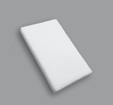 Rectangular white porous polyethylene block implant at an angle